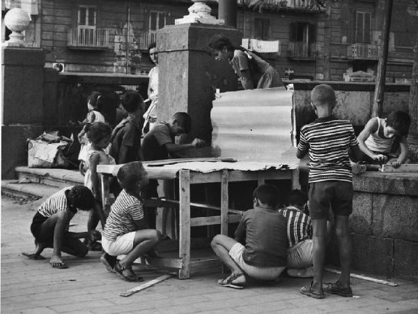 Napoli: Scugnizzi, si lavora/ Scene di vita varie. Napoli - Strada - Ritratto di gruppo - Bambini - Gioco dei falegnami