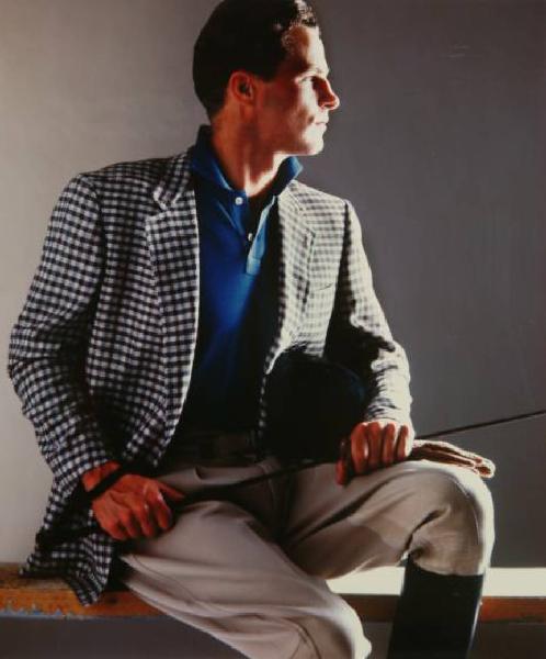 Campagna pubblicitaria per Trussardi Uomo - Sportswear - Modello seduto di profilo: giacca scozzese su polo blu, pantaloni e stivali da cavallerizzo - Frustino - Equitazione