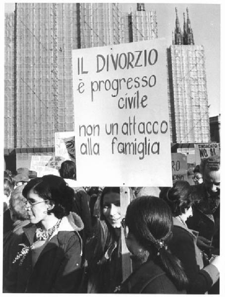 Manifestazione 8 marzo per la giornata internazionale della donna - Corteo in piazza del Duomo - Donna con cartello in difesa del divorzio - Mimosa - Il Duomo con impalcature