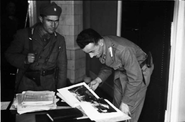 Viaggio in Jugoslavia. Zagabria: due militari che osservano un album fotografico