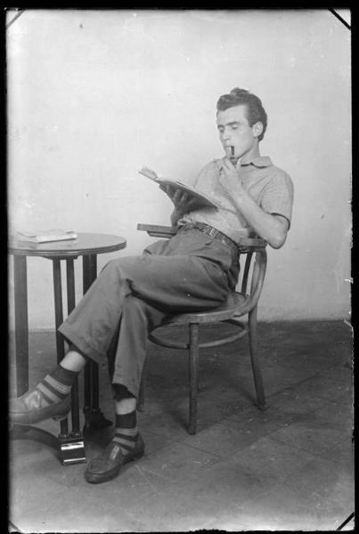 Uomo seduto con libro e pipa