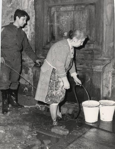Milano - Corso Garibaldi 117 - Casa senza acqua - Donna anziana riempie due secchi d'acqua da un allacciamento fatto dagli inquilini