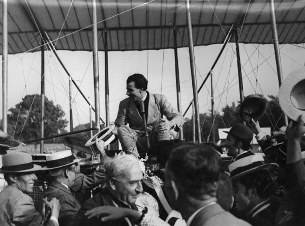 Scena del film "La conquista dell'aria" - Regia Romolo Marcellini - 1939 - Un attore non identificato, alla guida di un velivolo, riceve il plauso della folla attorno a lui
