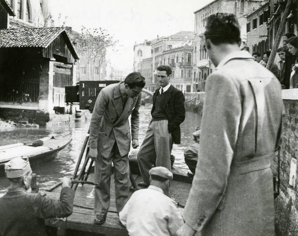 Sul set del film "I due foscari" - Regia Enrico Fulchignoni,1942 - A Venezia si girano le scene all'esterno del film. Si riconosce il regista Enrico Fulchignoni, in piedi con le mani in tasca, insieme a operatori non identificati.
