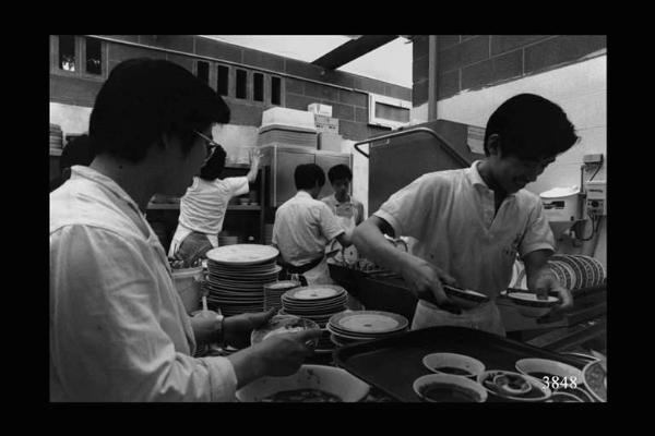 Lavapiatti di un ristorante cinese. Gruppo di ragazzi che lavano stoviglie. Immigrazione cinese.