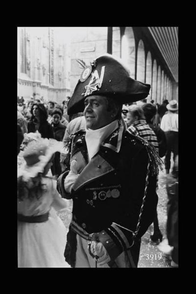 Uomo in costume da Napoleone sotto i portici di piazza Duomo.
