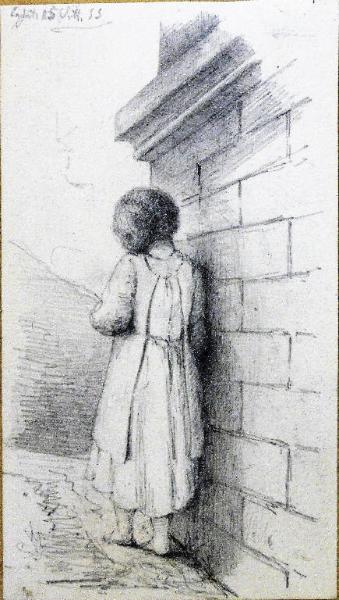 Bambina vicina a un muro