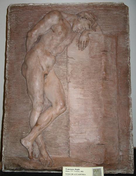 Uomo nudo appoggiato a blocco di pietra