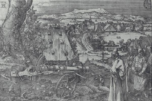 Cannone e un villaggio sullo sfondo