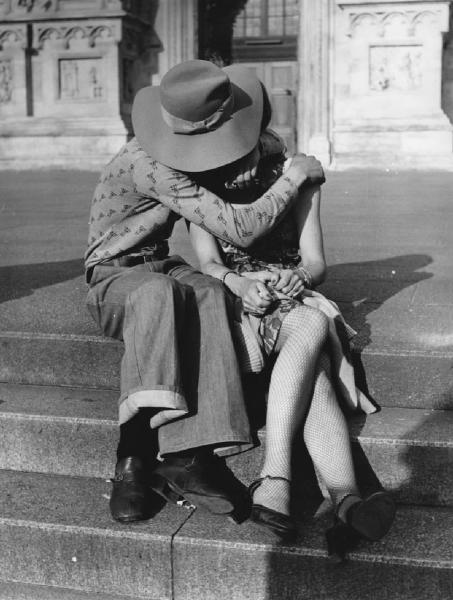 Piazza Duomo: Amore. Milano - Piazza del Duomo - Ritratto di coppia - Ragazzo con cappello e ragazza seduti sui gradini - Abbraccio, bacio