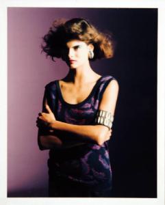 Campagna pubblicitaria per Trussardi Donna - Modella con abito sbracciato in maglia viola - Bracciale e orecchini metallici - Capelli cotonati