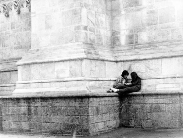 Piazza Duomo. Milano - Piazza del Duomo - Ritratto di coppia - Ragazzo e ragazza sul basamento del Duomo
