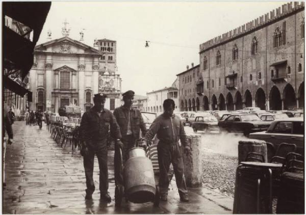 Mantova - Piazza Sordello - Netturbini in atto di trasportare un cestino per i rifiuti