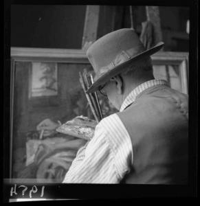 Ritratto maschile - Pittore seduto al cavalletto nell'atto di dipingere un quadro - Interno