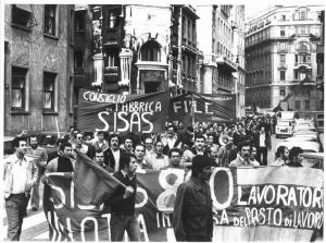 Sciopero dei lavoratori della Sisas contro i licenziamenti - Corteo in via Serbelloni verso la Prefettura - Operai urlano slogan - Striscioni - Bandiere