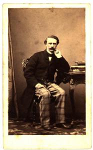 Ritratto maschile - Uomo con pantaloni a quadri, seduto a un tavolo