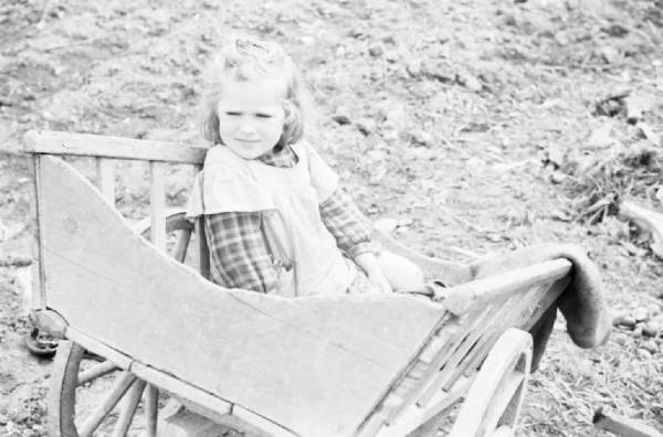 Viaggio in Jugoslavia. Tragitto Postumia-Lubiana - ritratto femminile - bambina seduta in un carretto