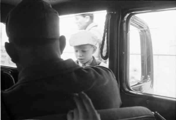 Viaggio in Jugoslavia. Zagabria: miliziano ustascia a bordo di un'automobile. Dal finestrino una giovane recluta