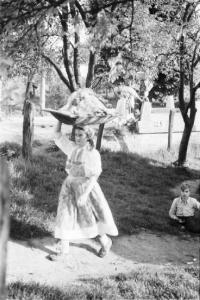 Viaggio in Jugoslavia. Sestine: lavandaia che torna dal fiume con i panni lavati portandoli in testa in una conca di legno