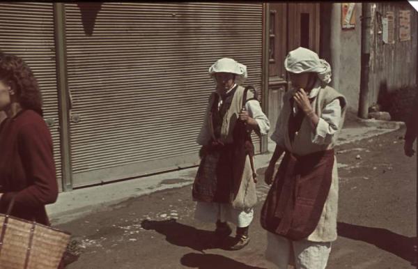 Viaggio in Jugoslavia. Mostar: scorcio in una via del centro - in primo piano una coppia di donne in abito locale