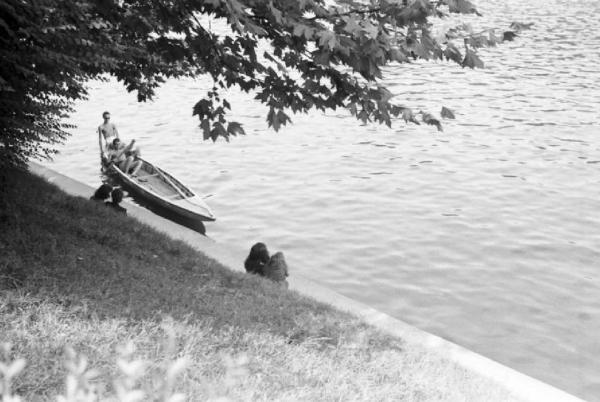 Roma - parco del Valentino. Scorcio aereo nei pressi di un piccolo laghetto - una barca con un uomo a bordo si dirige verso una donna, seduta di spalle sulla riva