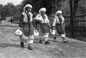 Viaggio in Jugoslavia. Yaitze: gruppo di tre donne bosniache in costume locale percorrono una strada sterrata portando dei cesti