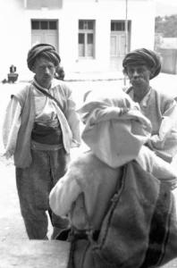 Viaggio in Jugoslavia. Yaitze: coppia di mercanti bosniaci in costume locale posa nella zona del mercato