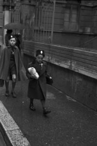 Italia Seconda Guerra Mondiale. Milano - raccolta della lana durante il regime fascista: coppia di giovani studenti con le buste per la lana sorpresi in una via del quartiere