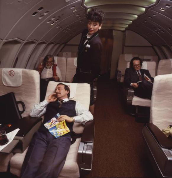 Alitalia. Interno della business class di un aeromobile - hostess sorveglia il riposo di un passeggero