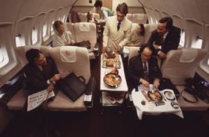 Alitalia. Interno della business class di un aeromobile - passeggeri e stewart durante il servizio pranzo
