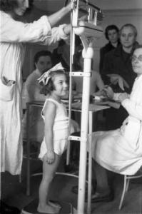 Francia dopoguerra. Bambina sulla bilancia durante una visita medica