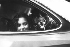 Brasile. Bambina e cagnolino guardano fuori dal finestrino di un'automobile