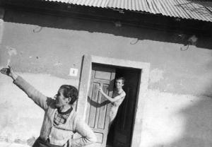 Donna e giovane uomo affacciato alla porta di casa