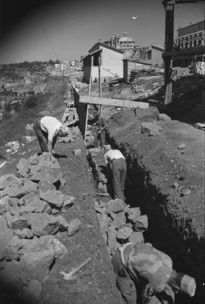 Italia Dopoguerra: Valmontone bombardata. Valmontone - Cantiere - Ritratto maschile di gruppo: operai al lavoro - Pietre