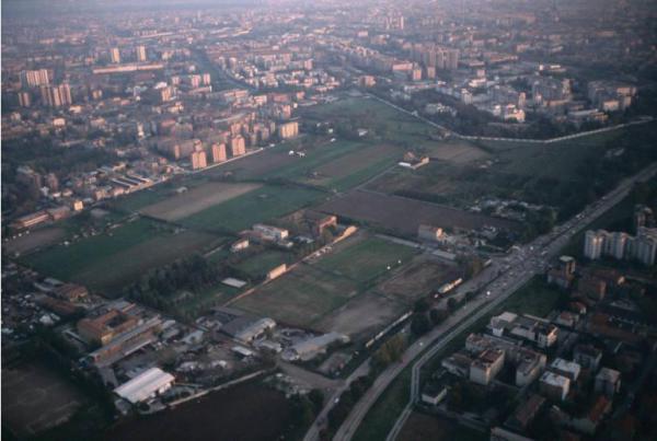 Milano - Parco Nord, settore Niguarda - Veduta aerea al tramonto da nord ovest a sud est - Capannoni industriali - Campi - Ville - Boschi - Via Enrico Fermi - Ospedale Niguarda - Sullo sfondo palazzi di Milano
