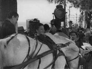 Set del film "Sissignora" - Regia Ferdinando Maria Poggioli - 1941 - Lo sceneggiatore Alberto Lattuada sul set che osserva l'attrice Maria Denis davanti a un cavallo