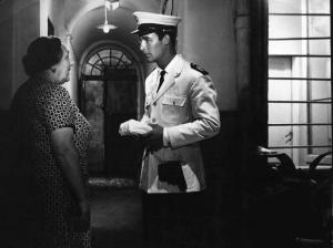 Scena del film "Carmen di Trastevere" - Regia Carmine Gallone - 1962 - L'attore Jacques Charrier in divisa da poliziotto e un'attrice non identificata