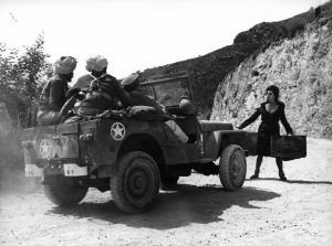 Scena del film "La Ciociara" - Regia Vittorio De Sica - 1960 - L'attrice Sophia Loren davanti ad una macchina di soldati non identificati.