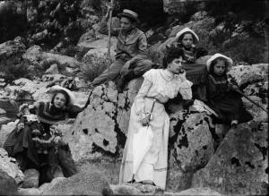 Val Brembana. Ritratto di signora con i figli durante un escursione in montagna lungo l'argine di un torrente. Bambina con bambola