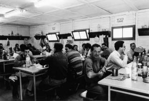Operai pranzano nelle baracche del cantiere U. B. S.