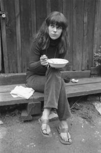 Svezia, Stoccolma, Yttersta Tvärgränd - Ritratto femminile - ragazza mangia seduta su di una panca di legno