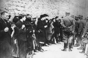 Seconda guerra mondiale - Polonia, Varsavia - Ghetto ebraico - Repressione della rivolta della popolazione ebraica - Strada - Arresto di massa di ebrei: uomini, donne e bambini contro un muro - SS in divisa - Antisemitismo - Nazismo