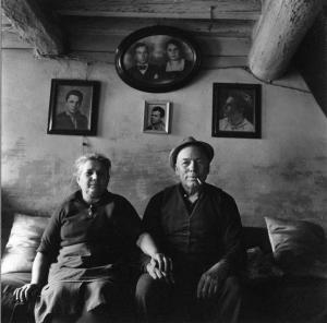 Gente del Po. San Benedetto Po - Abitazione, interno - Sala - Ritratto di coppia - Anziani seduti sul divano - Ritratti fotografici alle pareti
