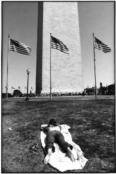 Stati Uniti d'America, Washington - Monumento per commemorare George Washington, obelisco di marmo - Prato - Donna prende il sole - Bandiere americane