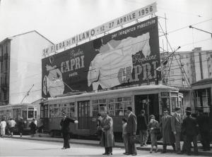 Milano - Viale - Fermata tranviaria - Cartellone pubblicitario con insegna della Fiera 1956 e la pubblicità delle camicie Popeline Capri