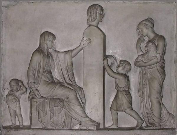 Due figure femminili e due fanciulli visitano un monumento sepolcrale