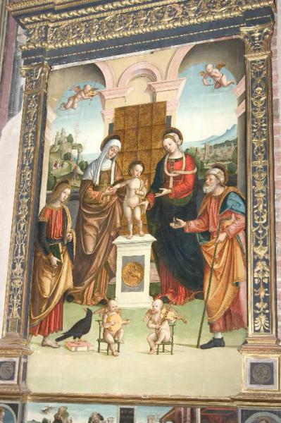 Gesù Bambino tra la Madonna, i SS. Anna, Gioacchino, Giovanni Evangelista e angeli musicanti